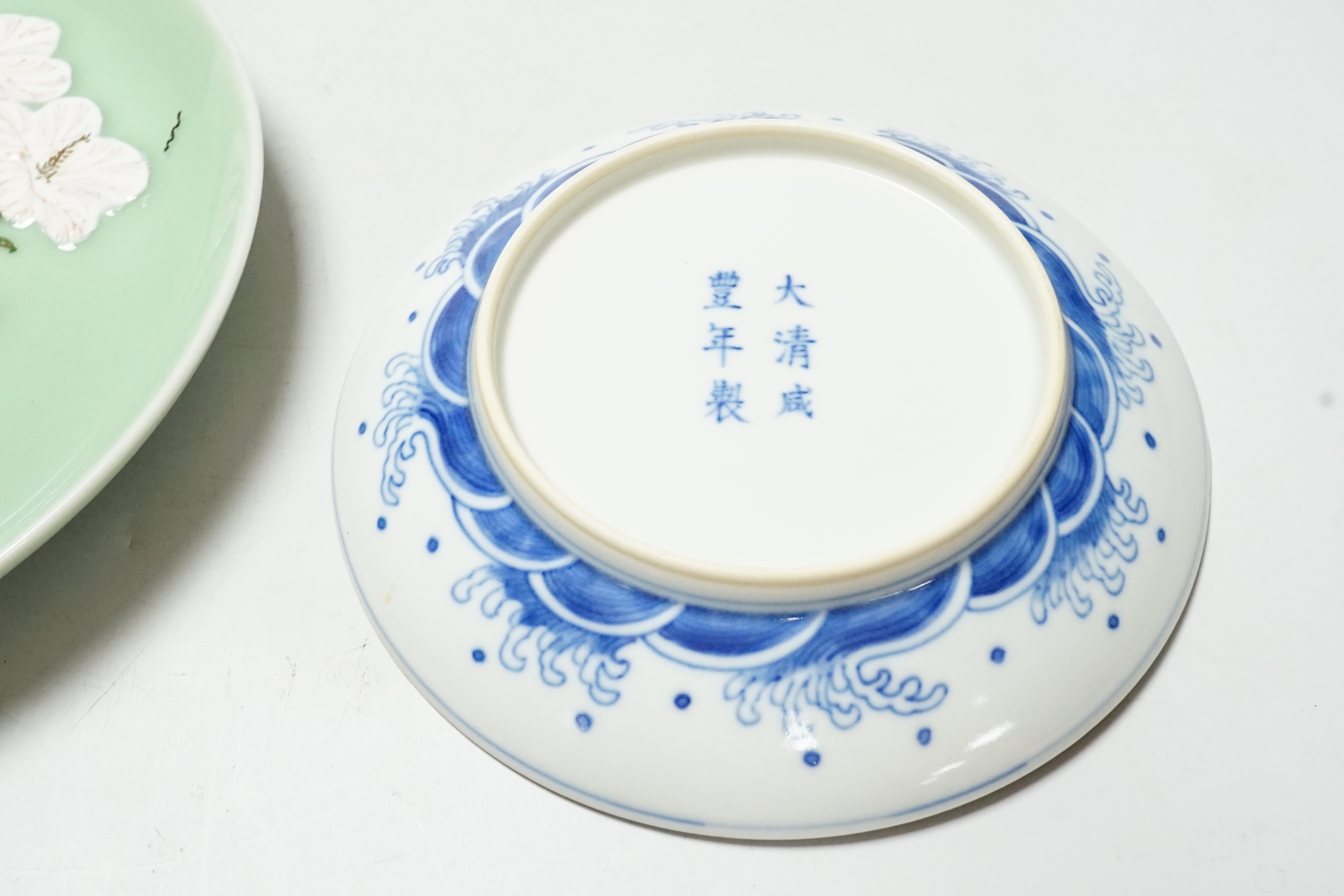 A Japanese celadon ground dish and a Chinese blue and white dish, largest 22cm diameter